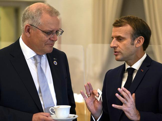 Australian Prime Minister Scott Morrison and French President Emmanuel Macron talk before the G20 leaders make a short visit to the Fontana di Trevi to throw a coin in the fountain to make a wish before the start of the second day of the G20 in Rome on Sunday, October 31, 2021. Picture: Adam Taylor