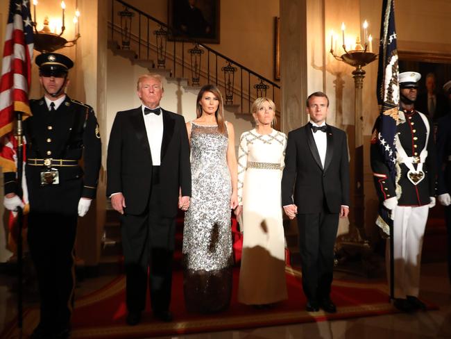 US President Donald Trump and First Lady Melania Trump stand with French President Emmanuel Macron and his wife, Brigitte Macron at the start of a State Dinner in the White House. Picture: AFP