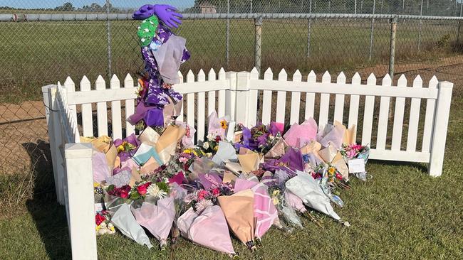 The memorial for the three crash victims has been moved across the road and a small fence has been erected.