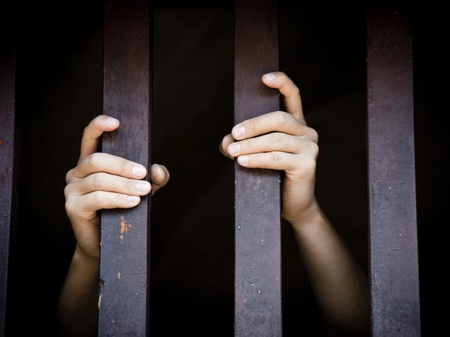 Prisoner, hands holding bars, jail, behind bars, children behind bars, asylum seeker generic, detention center, detained, jailed, shame, sadness, mental health, restriction, limitation generic, thinkstock