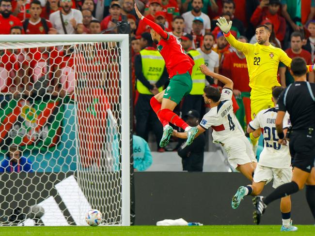 Morocco's forward #19 Youssef En-Nesyri (L) launches himself through the air to score against Portugal. Picture: Odd Andersen/AFP