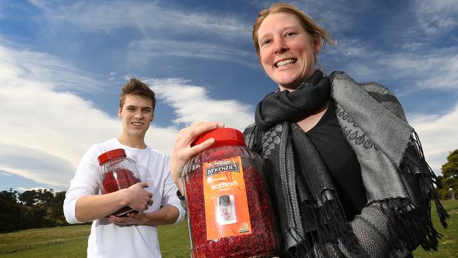 Patrick Noonan 20 of Glaziers Bay, left, and Sally Brown 33 of Cygnet with a big jar of Tas-Saff saffron. pic Sam Rosewarne