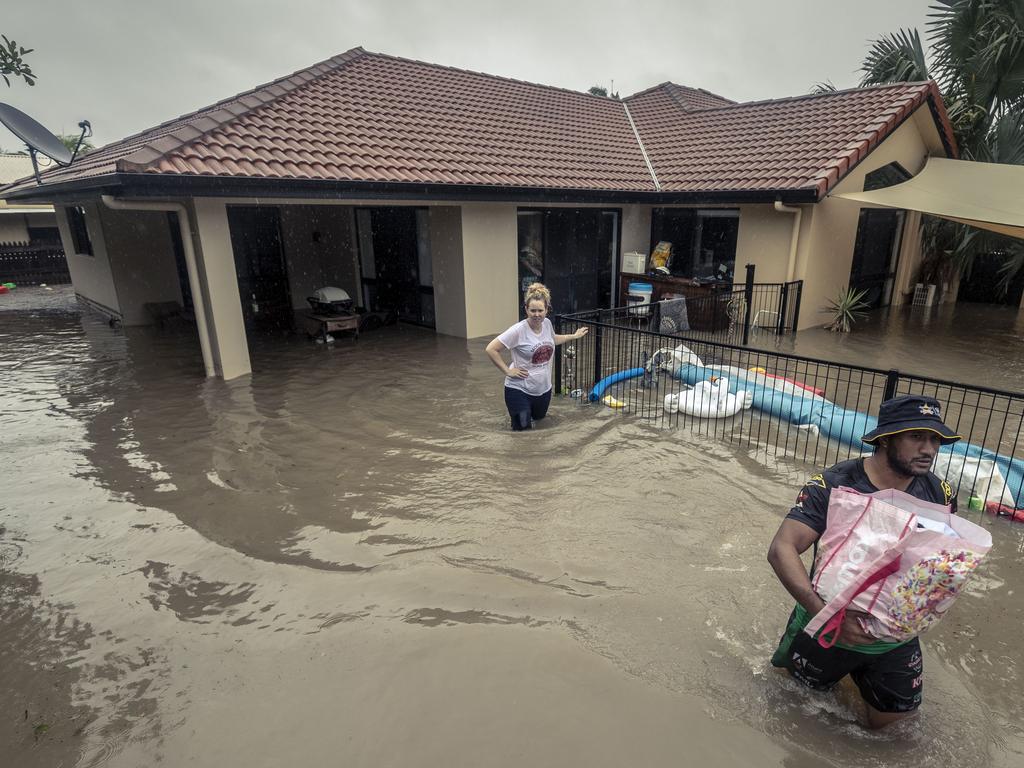 NRL player Kalifa Faifai Loa helps Danielle Josey and Lyndon Josey remove valuable belongings from their home in Idalia, Townsville. Picture: Glenn Hunt/The Australian