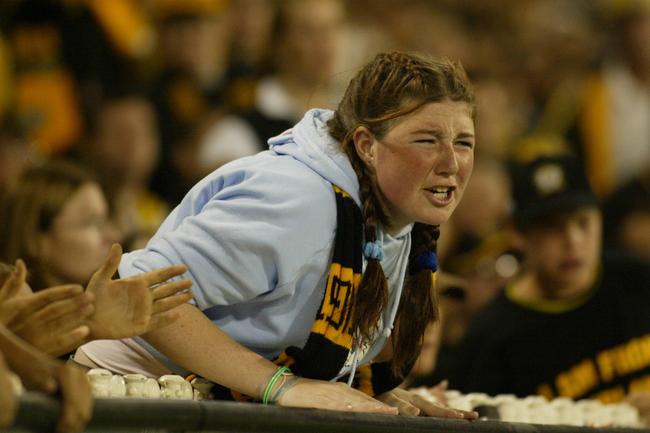 A supporter urges on the Tigers against Collingwood.