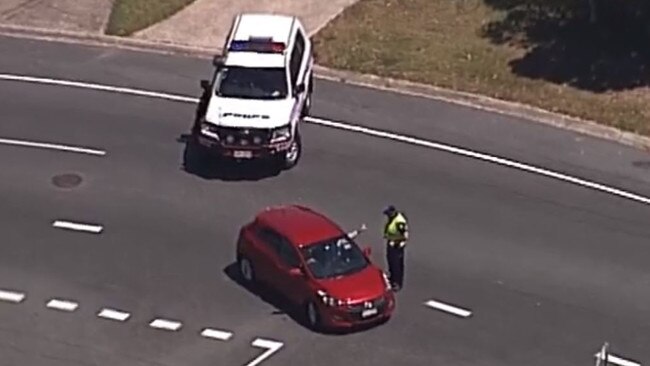 Police form a roadblock on Bribie Island where they are searching for two men following a shooting this morning at Rothwell. Picture: Channel 7