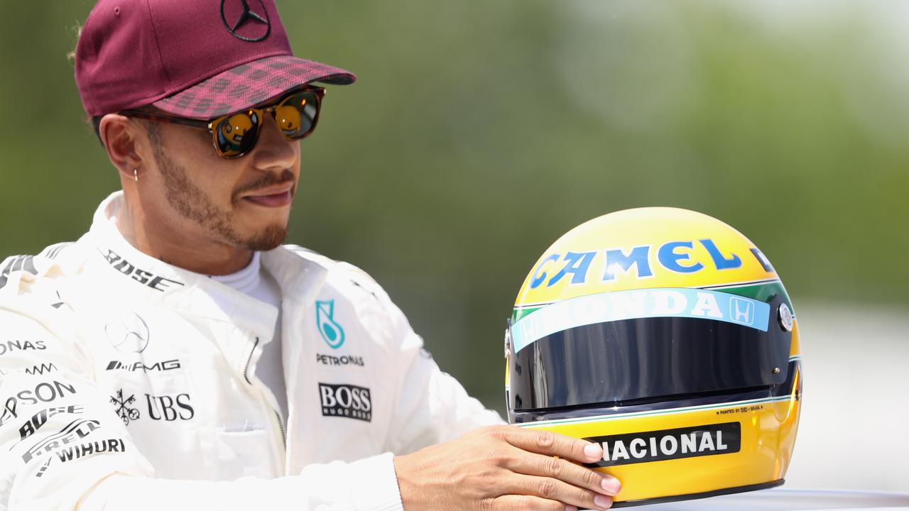 Lewis Hamilton with a commemorative helmet of his hero and F1 legend Ayrton Senna.