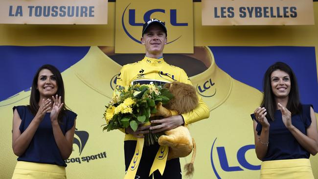 Great Britain's Christopher Froome celebrates his overall leader yellow jersey.