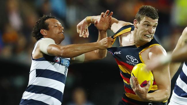 Josh Jenkins tries to break the tackle of Steven Motlop in last year’s preliminary final. Picture: Michael Klein