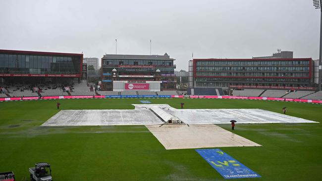 Rain brought a damp end to the fourth Test at Old Trafford, allowing Australia retention of the Ashes. (Photo by Oli SCARFF / AFP)