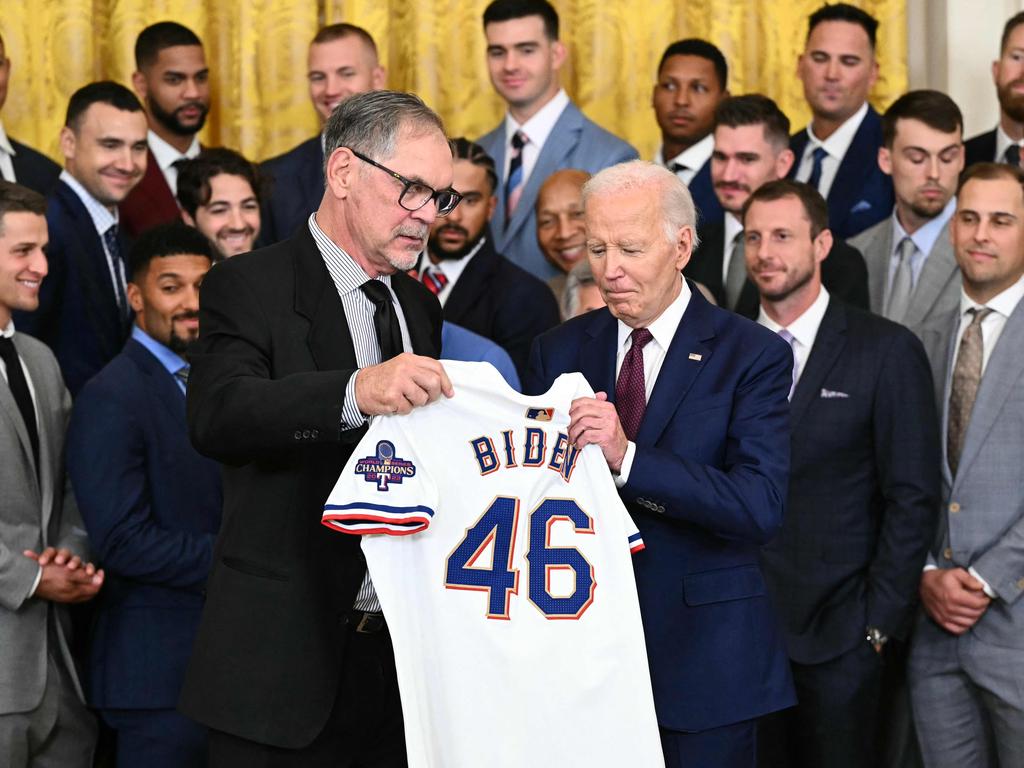 US President Joe Biden holds up a Texas Rangers jersey given to him by Rangers manager Bruce Bochy (L) during an event to celebrate the Texas Rangers' 2023 World Series championship in the East Room of the White House in Washington, DC. Picture: AFP