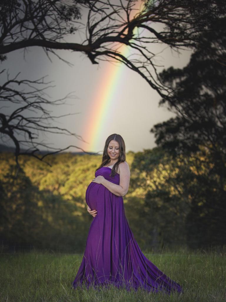 A pregnant Chloe Vella poses as a rainbow appears behind her. Picture taken December 2017 in Cooranbong. Picture: Shannon Smith