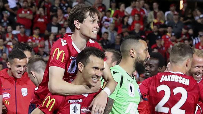 Adelaide United captain Isaias gives the match-winner Craig Goodwin a piggy back after last year’s FFA Cup final win. Picture Sarah Reed