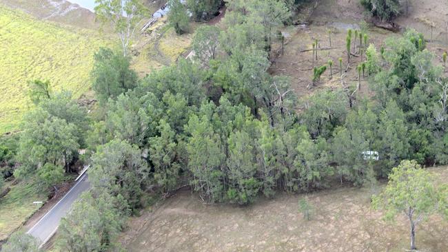 SAD: A van sits in Widgee Creek after it was washed away in flood waters during the 2013 floods. Photo Craig Warhurst / The Gympie Times