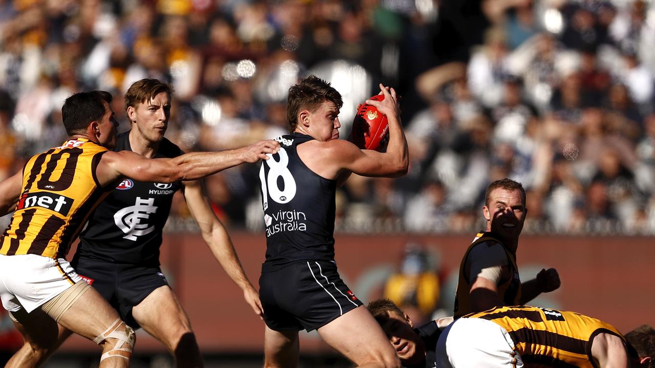 Sam Walsh of the Blues is tackled by Jaeger O'Meara.