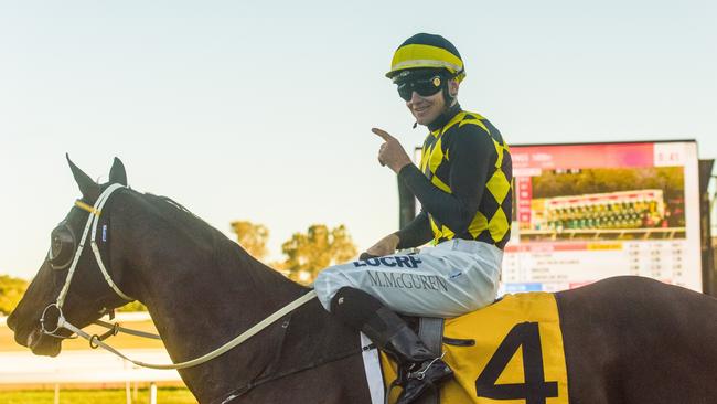 Jockey Matt McGuren waves to the crowd after winning the South Grafton Cup on Cogliere.