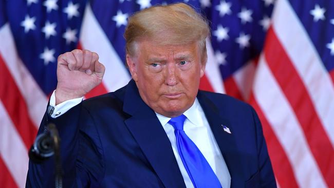 US President Donald Trump pumps his fist after speaking during election night in the East Room of the White House in Washington, DC.