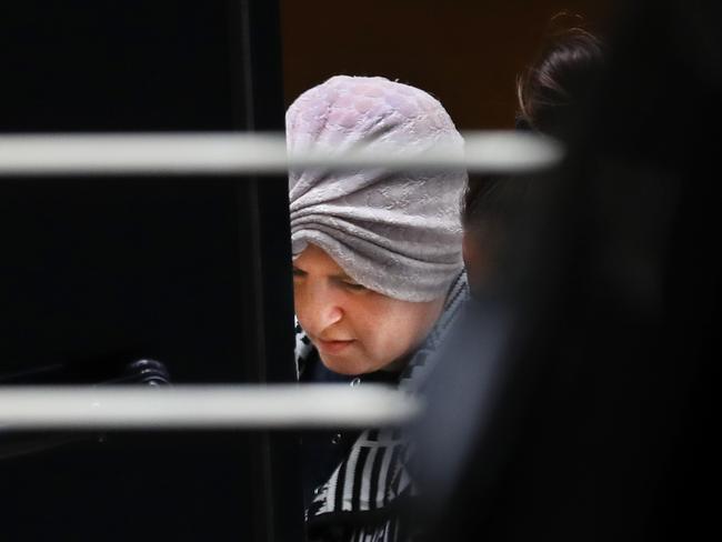 Malka Leifer is taken from the North Melbourne Police Station into a police van.