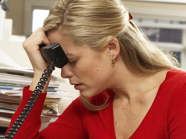 10 STEPS .. CAREER CHANGE Female office worker holding paperwork, holding phone against forehead