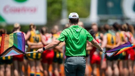 A goal umpire waving their Pride Round flags during the Round 6 match between Waratah and PINT. Picture: Pema Tamang Pakhrin