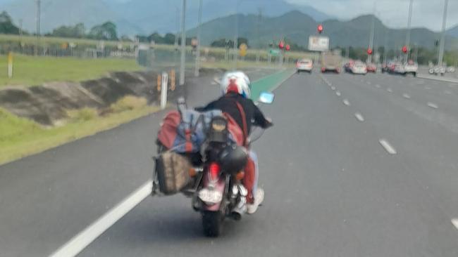 Heading south on the Bruce Highway near Gordonvale, this biker clearly was never taught how to balance his load. Picture: Facebook