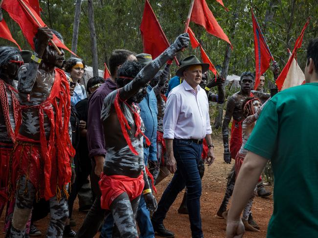 Anthony Albanese is escorted by the Red Flag Dancers during the Garma Festival at Gulkula in East Arnhem in 2023 ahead of the voice referendum. Picture: Getty