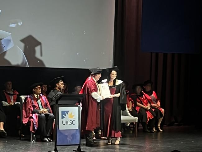 Graduates from the University of the Sunshine Coast's Fraser Coast campus celebrating at the Brolga Theatre.