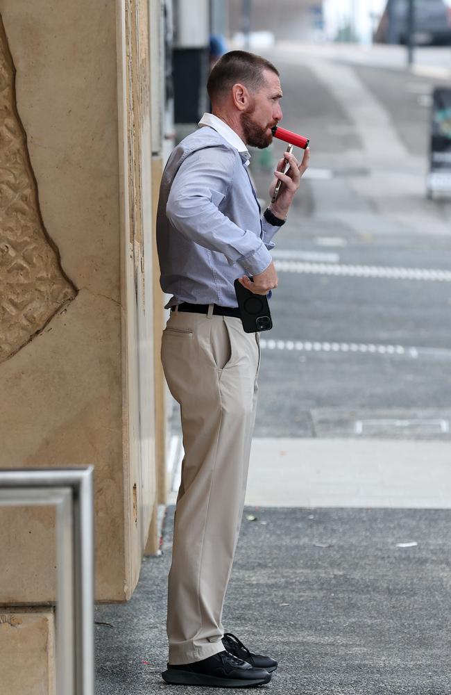 AFL star Jason Akermanis takes a soothing puff on a vape outside Ipswich District Court on May 31. Picture: Adam Head