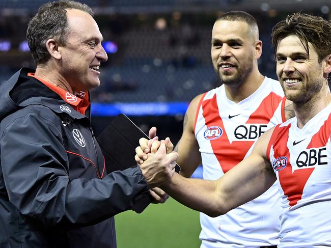 MELBOURNE, AUSTRALIA - JULY 11: Swans head coach John Longmire and Dane Rampe of the Swans celebrate winning the round 17 AFL match between Western Bulldogs and Sydney Swans at Marvel Stadium on July 11, 2021 in Melbourne, Australia. (Photo by Quinn Rooney/Getty Images)