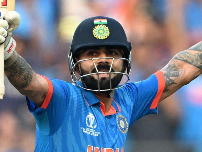 India's Virat Kohli celebrates after scoring a century (100 runs) during the 2023 ICC Men's Cricket World Cup one-day international (ODI) first semi-final match between India and New Zealand at the Wankhede Stadium in Mumbai on November 15, 2023. (Photo by Punit PARANJPE / AFP) / -- IMAGE RESTRICTED TO EDITORIAL USE - STRICTLY NO COMMERCIAL USE --