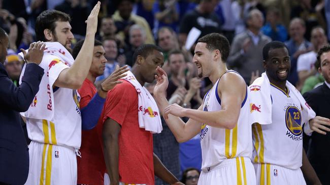 Klay Thompson #11 of the Golden State Warriors is congratulated by teammates after he was taken out of their game.