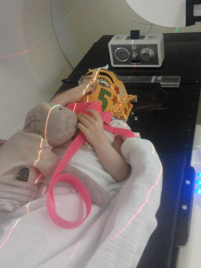 With her teddy bear as company Matilda undergoes treatment at a Brisbane hospital.