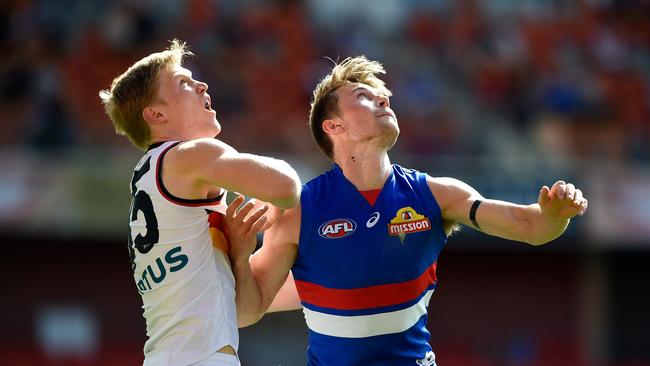 GOLD COAST, AUSTRALIA - AUGUST 16: Fischer McAsey of the Crows competes for the ball against Ryan Gardner of the Bulldogs during the round 12 AFL match between the Western Bulldogs and the Adelaide Crows at Metricon Stadium on August 16, 2020 in Gold Coast, Australia. (Photo by Matt Roberts/AFL Photos/via Getty Images)