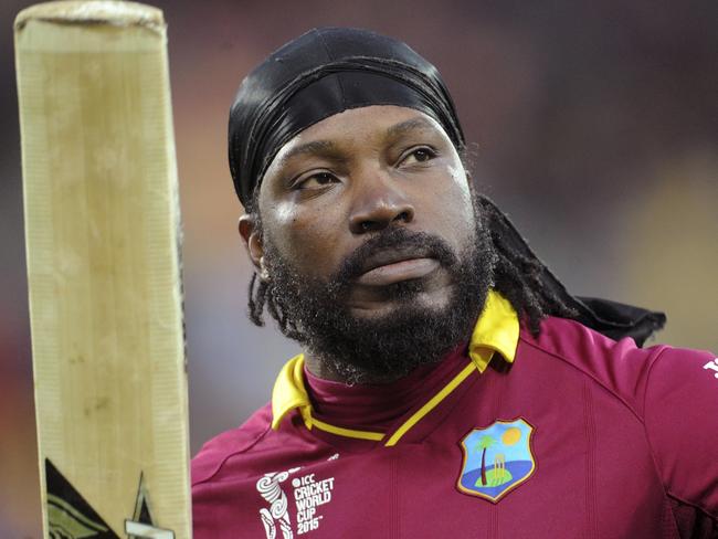 FILE - In this March 21, 2015 file photo, West Indies Chris Gayle waves his bat to the crowd as he leaves the field after he was dismissed for 61 runs while batting against New Zealand during their Cricket World Cup quarterfinal match in Wellington, New Zealand. The head of Cricket Australia has joined the criticism of Gayle’s suggestive comments to a female reporter during an interview broadcast live on Australian television, saying the former West Indies captain’s behavior bordered on harassment and were inappropriate in the workplace. After scoring 41 from 15 deliveries in the Melbourne Renegades win over the Hobart Hurricanes in Australia’s domestic Twenty20 Big Bash League on Monday, Jan. 1, 2016, the former West Indies captain suggested to television reporter Mel McLaughlin that the pair go out for a drink and made remarks about her appearance during a post-innings interview. He added, “Don’t blush, baby” during an awkward pause in the interview. (AP Photo/Ross Setford, File)