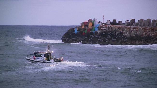 Authorities search for man washed off the southern breakwall at Coffs Harbour. Photo by Frank Redward