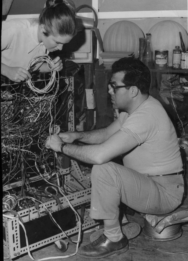 it was all hands on deck at theatre members Sophie Krantz and Hayes Gordon wire up lighting for the Ensemble Theatre in 1959.