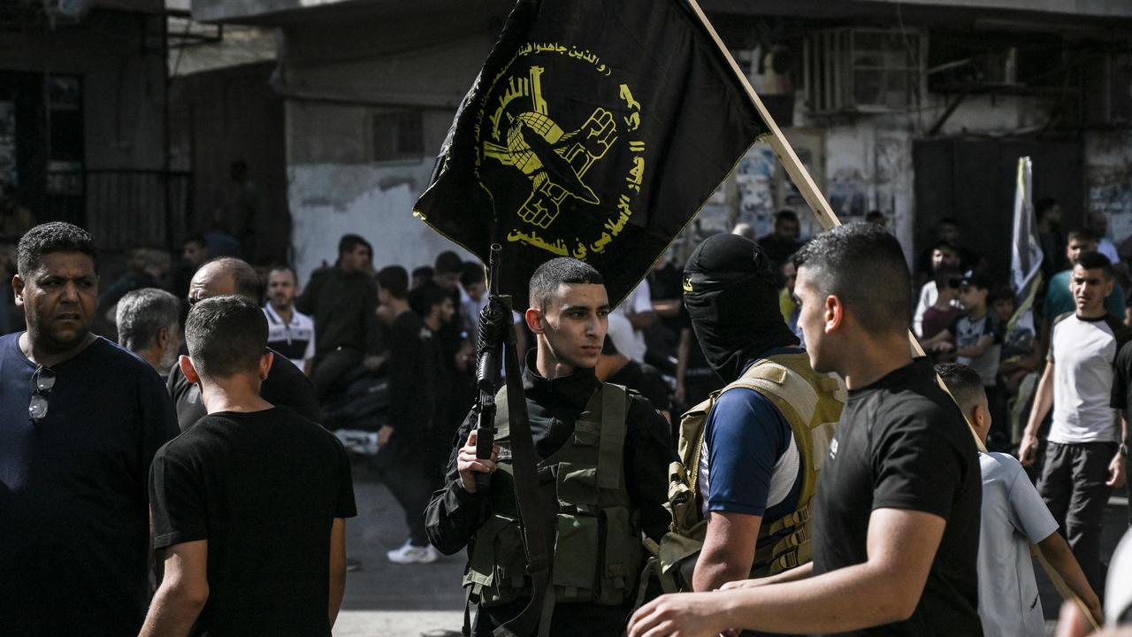 Armed Palestinians gather during the funeral. Picture: AFP