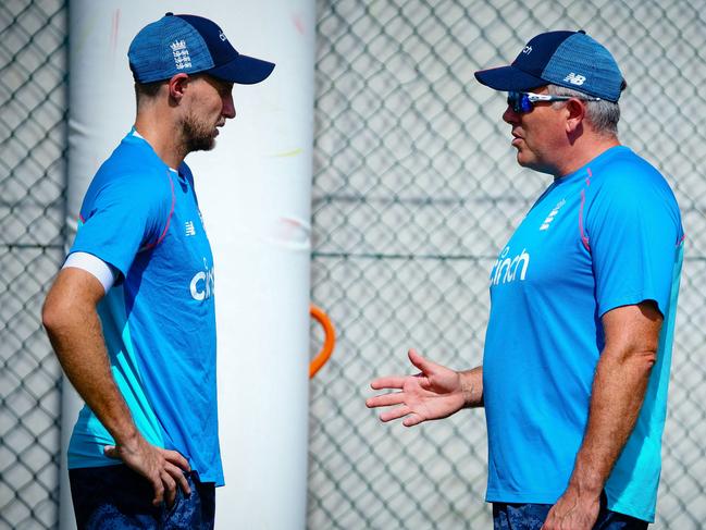 England captain Joe Root (L) and England coach Chris Silverwood (R) talk during training in Brisbane on December 7, 2021, ahead of the opening Ashes Test cricket match between Australia and England. (Photo by Patrick HAMILTON / AFP) / --IMAGE RESTRICTED TO EDITORIAL USE - NO COMMERCIAL USE--