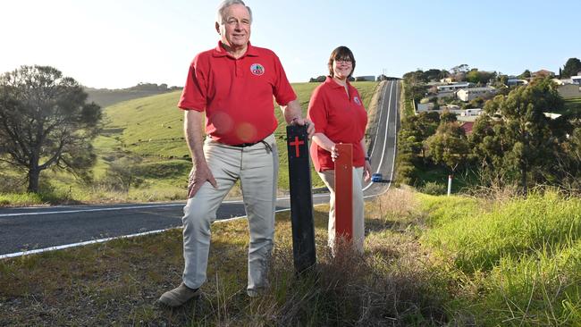 Michael Scott, the founding chairman of the Fleurieu Road Safety Group, with P-plater Tallara Pengilly, with roadside crash markers on a council-owned road. Picture: Keryn Stevens