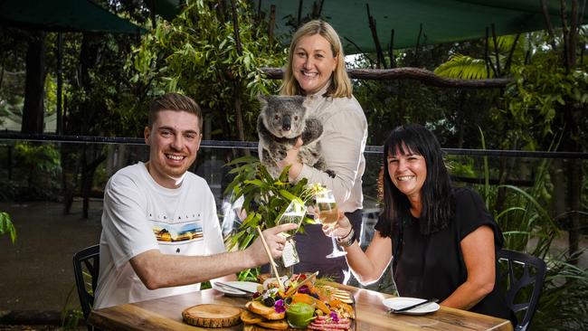 Nixon Brass and Mara Douglas with ''CJ' the koala held by wildlife officer Kylie Lawless at Currumbin Wildlife Sanctuary. Picture: Nigel Hallett