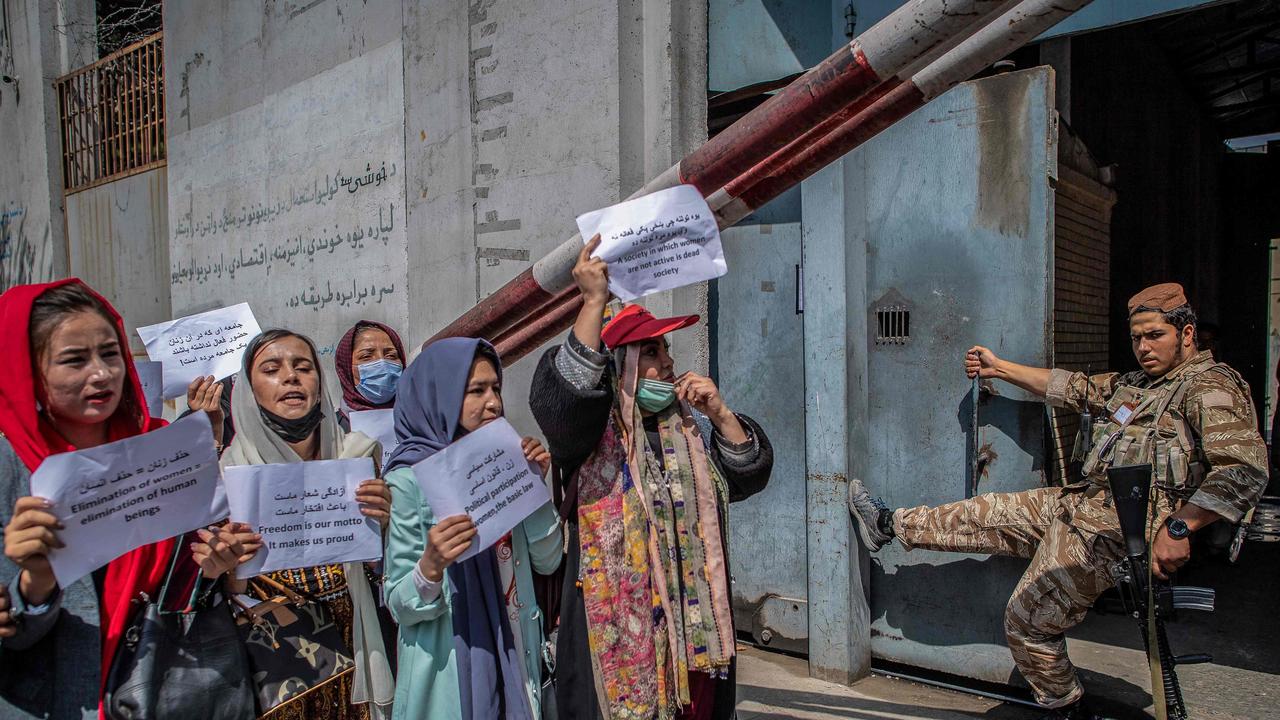 A Taliban fighter watches as Afghan women demonstrate in Kabul, demanding better rights for women. Picture: Bulent Kilic/AFP