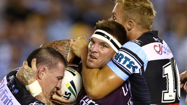 Broncos prop Josh McGuire is wrapped up by Sharks forwards Paul Gallen and Matt Prior. Picture: Gregg Porteous