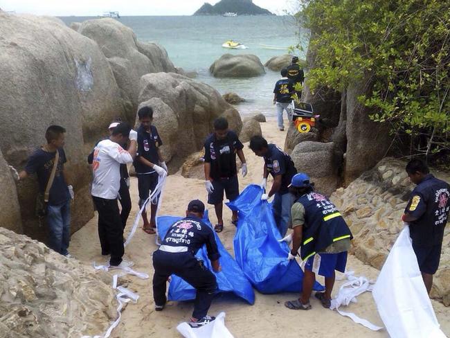 Thai rescue workers wrap the bodies of British tourists David William Miller and Hannah Victoria Witheridge who were found dead on a beach of Koh Tao island in September 2014.