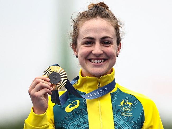 Australia's Grace Brown celebrates with her gold medal on the podium during the medal ceremony for the women's road cycling individual time trial during the Paris 2024 Olympic Games in Paris, on July 27, 2024. (Photo by Anne-Christine POUJOULAT / AFP)