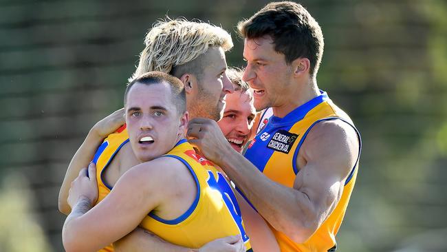 Shane Doherty celebrates a goal with Macleod teammates. Picture: Josh Chadwick