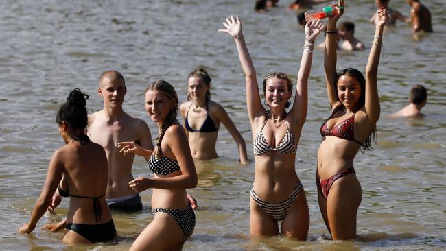 Londoners take a dip at Hampstead Heath ponds as the temperature soars on Saturday. Picture: AFP