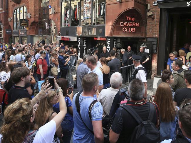 People queue outside the Cavern Club before the gig. Picture: Peter Byrne/PA via AP