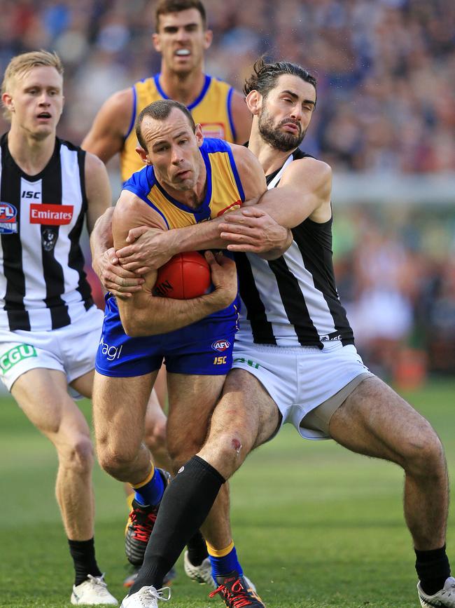 West Coast captain Shannon Hurn is tackled by fellow South Aussie All-Australian, Collingwood ruckman Brodie Grundy. Picture: Mark Stewart