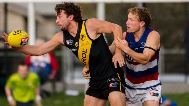 Glenelg’s Matthew Snook is tackled by Central District’s Travis Schiller at the Bay on Saturday. Picture: Morgan Sette