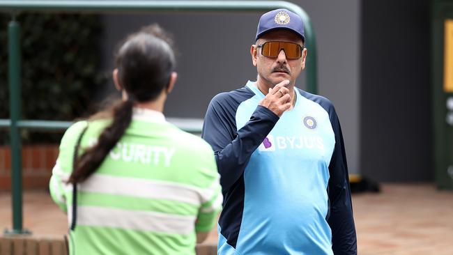 Indian coach Ravi Shastri walks past an SCG security guard without a mask