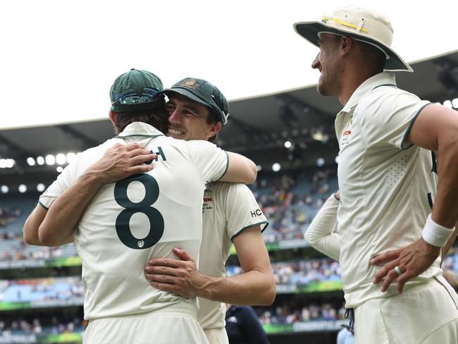 Australia's Mitchell Marsh (L), Pat Cummins (C) and Mitchell Starc celebrate after winning in Melbourne. Picture: AFP